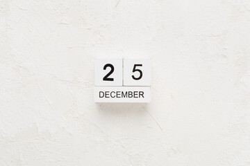 Calendar with date December 25 on concrete background, top view