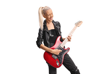 Fototapeta premium Beautiful female rock musician playing a guitar