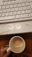 coffee cup and white computer keyboard in working time