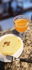 breakfast table with juice and fruits and pancakes