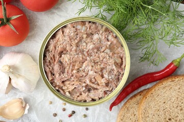 Canned meat in tin can served on table, flat lay