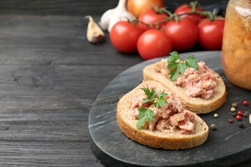 Sandwiches with canned meat served on wooden table, closeup. Space for text