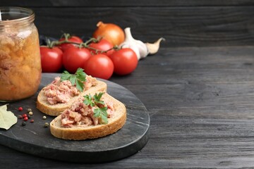 Sandwiches with canned meat served on wooden table, space for text