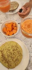 breakfast table with juice and fruits and pancakes