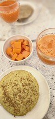 breakfast table with juice and fruits and pancakes
