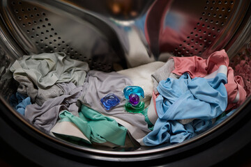 Laundry in Progress Clothes and Detergent Pod are currently in the Washer, working hard