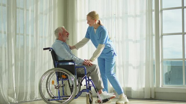 Help support retirement healthcare. Nurse helping old man in wheelchair. Patient and woman in nursing home for medical caregiver. Nurse taking care of paralyzed man in chair for people with disability