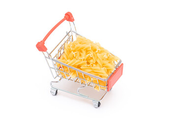 Uncooked Fusilli Pasta in Small Shopping Cart Isolated on White Background. A Crisis: Buying Cheap Food. Classic Dry Spiral Macaroni. Italian Culture and Cuisine. Raw Pasta - Isolation