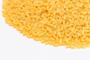 A Heap of Uncooked Chifferi Rigati Pasta on White Background. Fat and Unhealthy Food. Classic Dry Macaroni Texture. Italian Culture and Cuisine. Raw Pasta