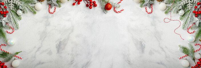 Christmas and New Year background with fir branches with holiday decorations and pine cones on a...