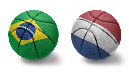 Fototapeta premium basketball balls with the national flags of netherlands and brazil on the white background.