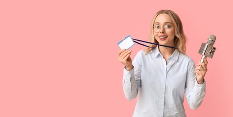 Portrait of female journalist with microphone and badge on pink background with space for text