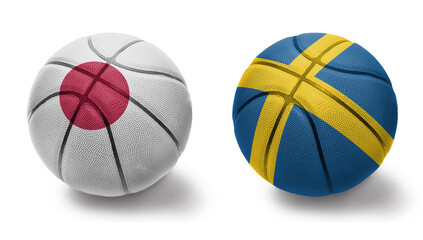 Fototapeta premium basketball balls with the national flags of sweden and japan on the white background.