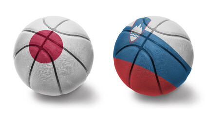 basketball balls with the national flags of slovenia and japan on the white background.