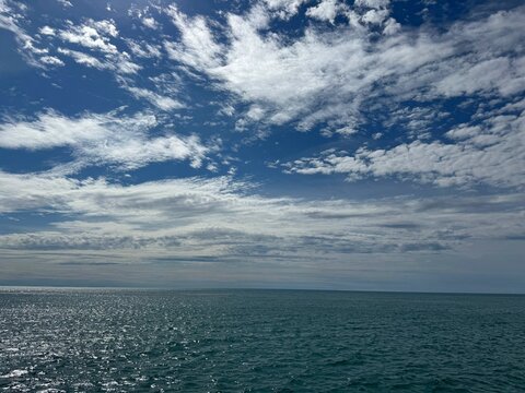 Sky, clouds, sea calm shiny waters