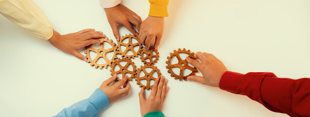 Startup company employee joining cogwheel gear together symbolize function productive system and...