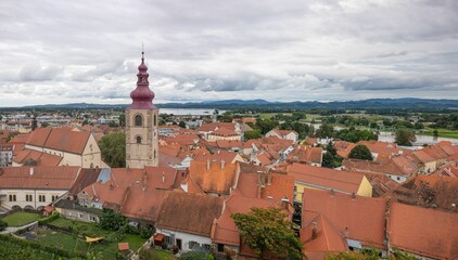 Obraz premium View of a medieval town with its red-tiled roofs, narrow streets, and a prominent church tower