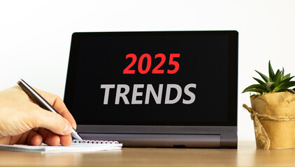 Planning 2025 trends new year symbol. Concept words 2025 Trends on beautiful black tablet. Beautiful white background. Businessman hand. Business 2025 trends new year concept. Copy space.