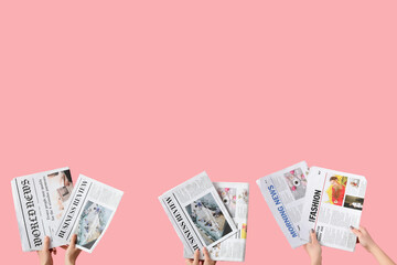 Women with newspapers on pink background