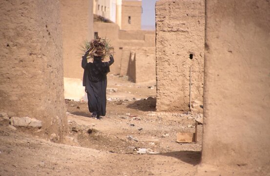 Women in nikab walking in a street of Shibam, Yemen,