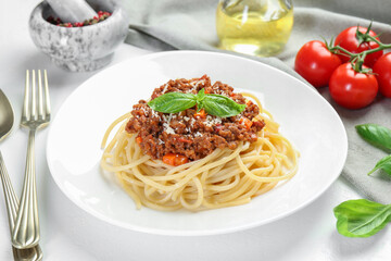 Delicious pasta bolognese served on white table