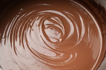 Chocolate dough in bowl as background, closeup