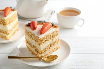 Piece of delicious carrot cake on white wooden table, closeup