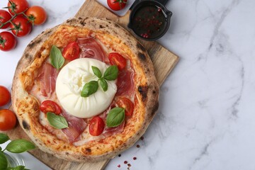 Delicious pizza with burrata cheese on white marble table, top view. Space for text