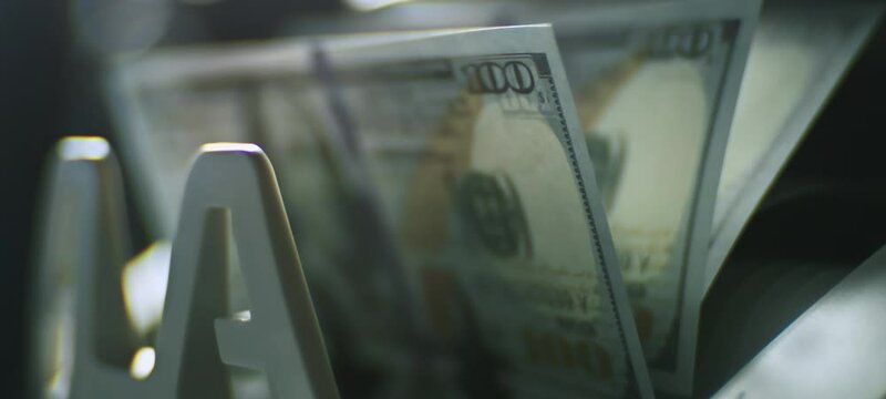 Super slow-motion video of counting dollars in the bank with machine equipment. Bank money counter and money and economy concept