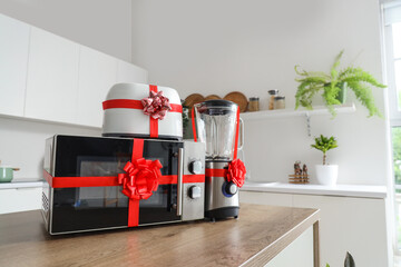 Different household appliances on counter as gift in kitchen