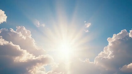 Radiant Sunlight Breaking Through Fluffy Clouds in a Clear Blue Sky