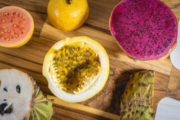 Different kind of tropical fruits, on a wooden background. Flatlay background.