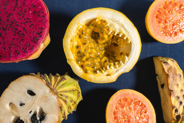 Different kind of tropical fruits, on a blue background. Flatlay background.