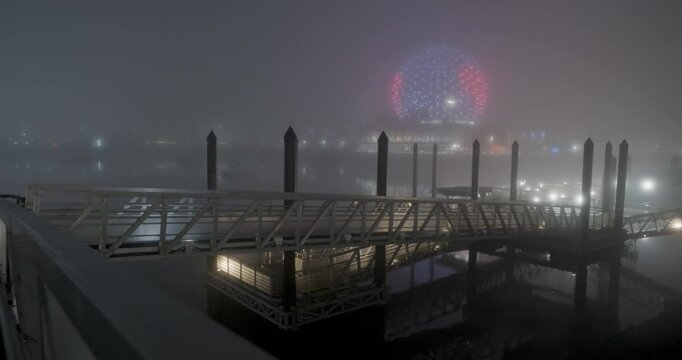 boats in the harbor during a foggy winter night
