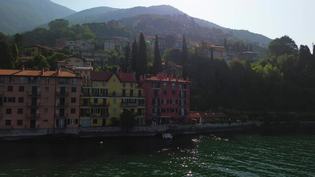 Aerial view of Lake Como. city ​​center. Bell tower. Tourism and romance. Mountains around the lake. Red roofs. Green Planet. Sailing yacht. Powerboat. travel to Italy, Bellano, 12.09.2024