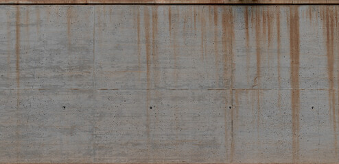Fototapeta premium Panoramic background of a concrete wall with a rough texture and rust stains