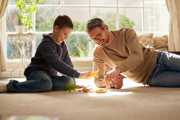 Father, son and play with toys at house for plastic dinosaur, learning and fantasy games of animal education. Smile, family and reptiles with creative development, bonding together and childhood fun