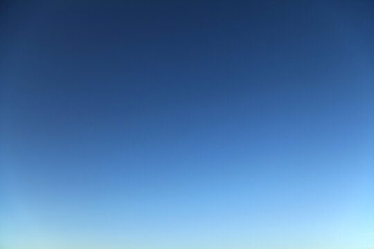 Atmosphere and clear sky. Blue-sky with a yellow glow after sunset. Blue sky and good weather in autumn. Deep blue cloudless sky. Clear weather in late autumn. Deep-blue color of sky in fall time