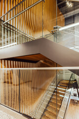 Fototapeta premium Wooden staircase with modern design in open space office 