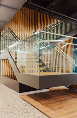 Wooden staircase with modern design in open space office 