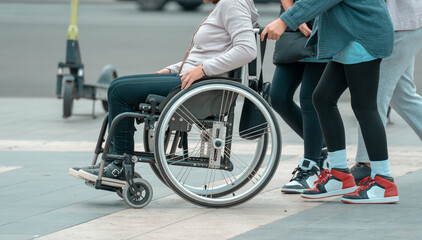 A man in a wheelchair crosses the street.