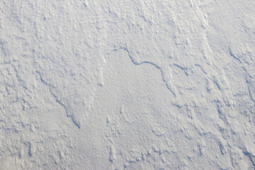 texture of snow that lies in layers after a storm