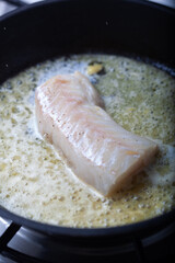 Cod fillet on a skillet.