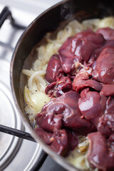 Chicken livers are being cooked with onions.