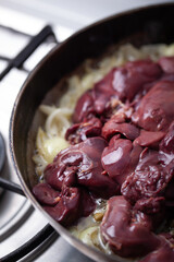 Chicken livers are being cooked with onions.