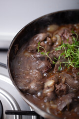 Chicken livers are being cooked with onions and thyme.