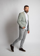 handsome man posing in front grey background