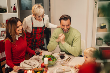 Family celebrating christmas together around the table