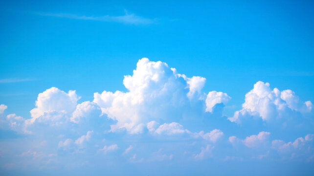 Fluffy clouds in a partly cloudy sky add charm and depth to a clean copy space background making it perfect for any visual project