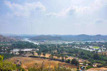 Obraz premium Aerial view of mountains, fields and rivers in the famous historical city of Hampi